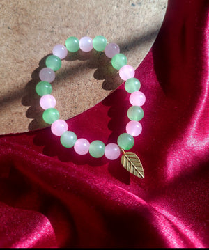 Pink and Green glass beaded bracelet with leaf cham
